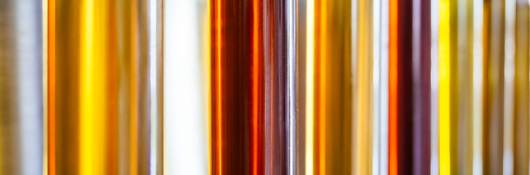 Small vials of palm oil stand in a row